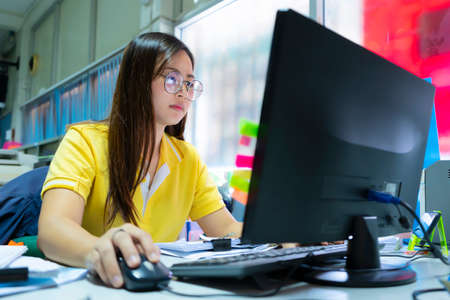 Business women are using computers to analyze business data, marketing, purchasing in the office.の写真素材