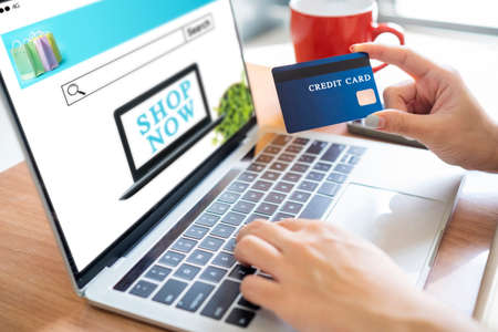 Online Shopping Website on Laptop. Easy E-commerce Website Shop by Smartphone and Laptop. Close up Hands Using Smartphone Shopping Cart read Online Article, Blog. Digital Payment gatewayの写真素材