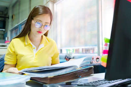 Business women are analyzing business data with a lot of documents, marketing, purchasing in the office.の写真素材
