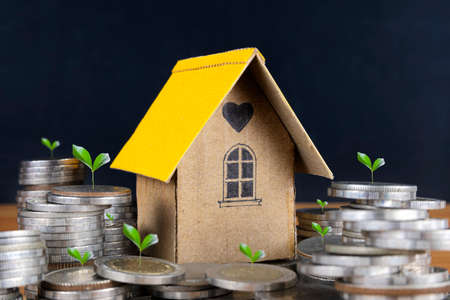 Home model on Coin Saving Ideas for Investing in Mortgage Funds, Finance, and Growing Interest Rate Home Loans.の写真素材