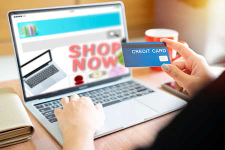 Online Shopping Website on Laptop. Easy E-commerce Website Shop by Smartphone,   and Laptop. Close up Hands Using Smartphone Shopping Cart read Online Article, Blog. Digital Payment gatewayの写真素材