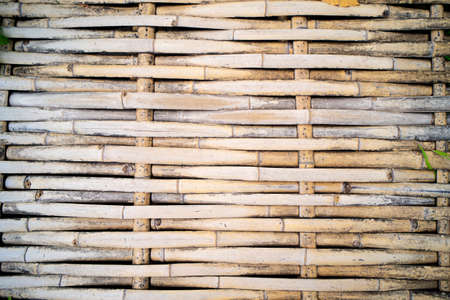 Bamboo sticks wooden background with thread unitingの写真素材