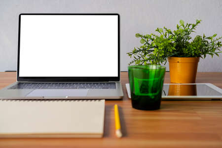 Conceptual workspace, Laptop computer, Notebook, tablet with blank white screen on tableの写真素材