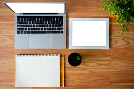 Conceptual workspace, Laptop computer, Notebook, tablet with blank white screen on table, Top viewの写真素材