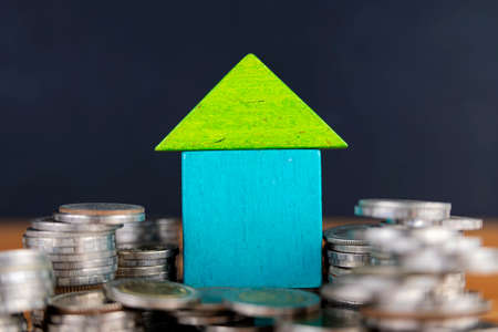 House on a coin pile, real estate investment, save money with a coin pile, business and financial...