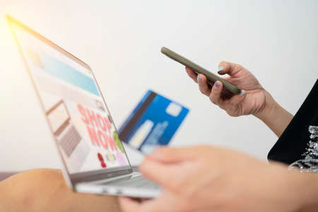 Online Shopping Website on Laptop. Easy E-commerce Website Shop by Laptop. Close up Hands Using Smartphone Shopping Cart read Online Article, Blog. Digital Payment gatewayの写真素材