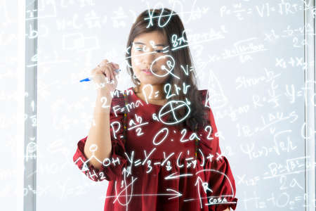 Mathematical concept. The teacher wrote the mathematical formula on the glassの写真素材