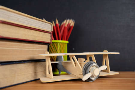 Airplane model on old educational book in library for history education and commemoration for Wright...