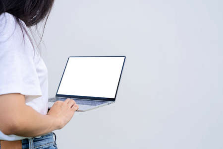 Asian businesswoman working on laptop computer isolated over white background. To put text as advertising mediumの写真素材