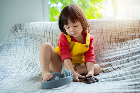 child girl happy look smart phone. asian child. Child development, technology and lifestyle conceptの写真素材
