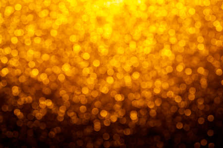 Gold abstract bokeh glitter vintage lights background. dark gold and black. defocusedの写真素材