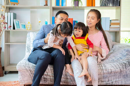 Happy Asian family playing together at sofa, home living room at home and weekend for familyの写真素材
