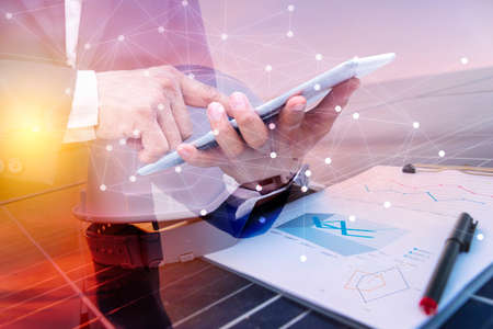 A business man using a tablet computer. Science solar energy, engineer working on checking and...