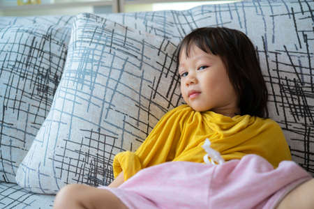 Close-up portrait of her she nice attractive lovely charming cute calm peaceful dreamy preteen girl lying on divan having rest time in light white interior living-room house indoorsの写真素材