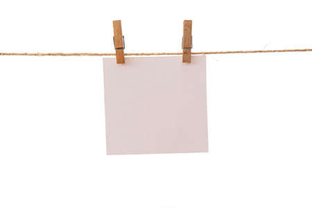Empty color paper sheets for notes, frames that hang on a rope with clothespins and isolated on white. Blank cards on rope mockup template.の写真素材