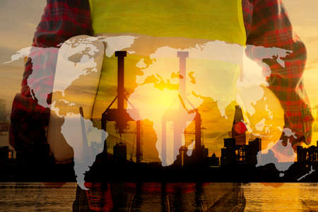 Silhouette of Engineer and worker checking project at building site background, construction site at sunset in evening time, world map.の写真素材
