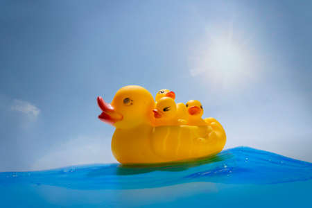 A floating mother of rubber ducks with three young children, like a leader with a burden to be responsible.の写真素材