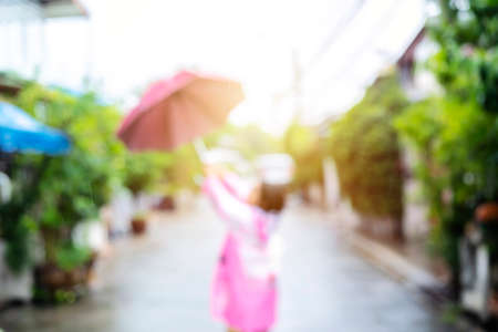 Blur background of Asian child playing outdoors. Happy child in the rain.の写真素材