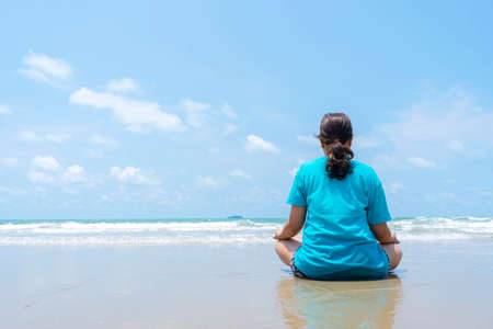 Young woman practicing yoga outdoors. Harmony and meditation concept. Healthy lifestyleの写真素材
