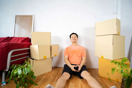 Happy at new home. Man having fun together. Moving house day and interior renovation conceptの写真素材