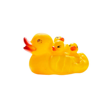 Mily of yellow toy ducklings on white background, motherhood conceptの写真素材