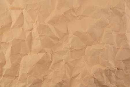 Old crumpled parchment folded paper texture brown color nobody for your backgroundの写真素材