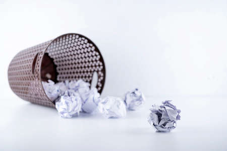 No idea - Crumpled paper can recycle was thrown to metal basket bin. Overflowing waste paper in office garbage bin. Junk, wastepaper in rubbish isolated on white backgroundの写真素材