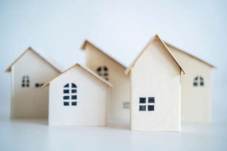 Paper house mockup on white background. Housing business concept. paper house model from group of house, selective focus, Planning to buy property. A symbol for constructionの写真素材