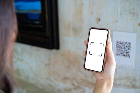 Scanning QR code with mobile smart phone. Isolated on white background. Qr code payment, E wallet , cashless technology concept.の写真素材
