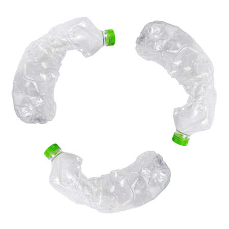 Three crashed plastic bottles on white isolated background form resycling sign. Plastic utilisation concept. Attractive ecological problem positive poster.の写真素材