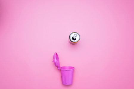 Top view of the trash and aluminum can waste isolated from the pink recycle concept.の写真素材