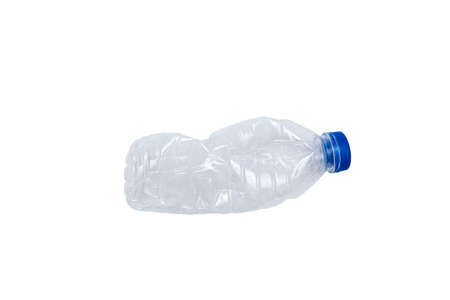 Transparent plastic bottle, blue bottle cap crushed on white background A still image taken in a studio with a softbox.の写真素材