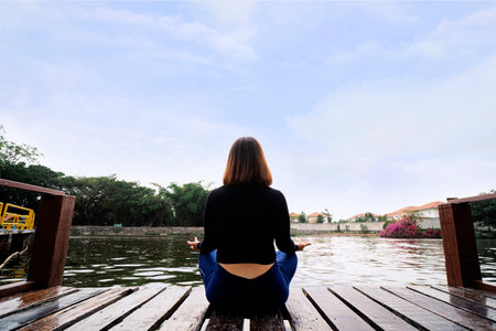 Woman do yoga relax outdoor. Woman exercising pose vital and meditation for fitness lifestyle club at the outdoors nature background. Healthy and Yoga Conceptの写真素材