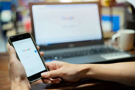 Bangkok. Thailand. 9 June 2020 : A woman is typing on Google search engine from a laptop. Google is the biggest Internet search engine in the world.のeditorial素材