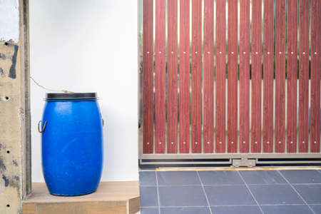 Bin front yard. Blue waste bin located in front of houses for littering and convenient for municipal...
