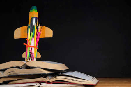 Startup Concept - Creative Rocket With Colorful Pencils And Books On Desk - Back To Schoolの写真素材