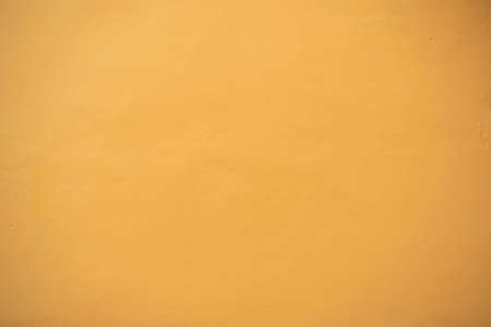 Yellow wall texture. Horizontal yellow plaster wall concrete texture backgroundの写真素材