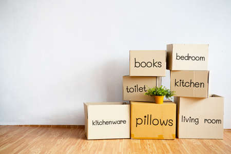 Stacks of moving boxes and housewares in the living room It is clearly stated.の写真素材