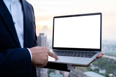 Young man working on his laptop with blank copy space screen for your advertising text message in office, Back view of business man hands busy using laptop at officeの写真素材