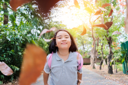 Funny little girl in the summer on nature little girl, has happy fun with cheerful smiling face. Carefree in the parkの写真素材