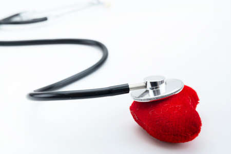 Red heart with stethoscope on white background, heart health, health insurance concept, world health day.の写真素材