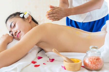 Spa Woman. Brunette Getting a Salt Scrub Beauty Treatment in the Health Spa. Body Scrub.の写真素材