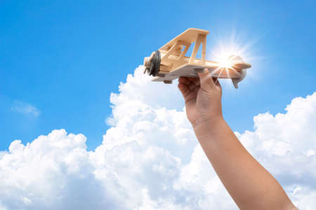 Toy balsa wood airplane in the sky. Toned filtered imageの写真素材