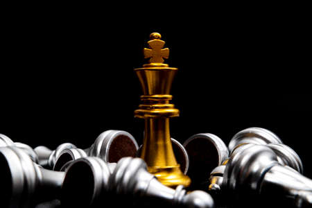 Gold queen chess surrounded by a number of fallen silver chess pieces , business strategy conceptの写真素材