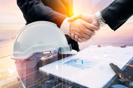 Double exposure of handshake, working solar station photovoltaic panels. Science solar energy,engineer working on checking and maintenance equipment at industry solar powerの写真素材