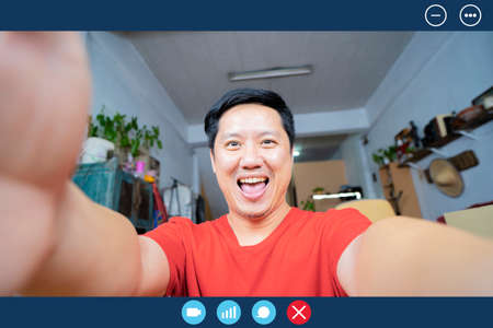 Headshot portrait screen view of smiling man sit on couch at home talk on video call with relatives,...