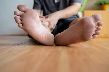 Knee pain disease concept. Hands on leg as hurt from Arthritis, gout or infections.の写真素材