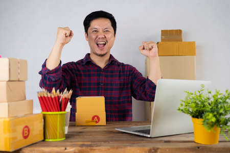 successful man working and using laptop computer to selling product online on table at homeの写真素材