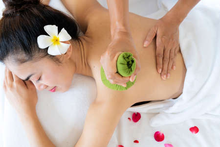 Beautiful young Asian woman relaxing during full body massage at spa environment, Leisure. lifestyle beauty woman conceptの写真素材