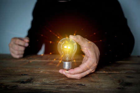 hand holding light bulb. idea creativity concept with innovation and inspiration